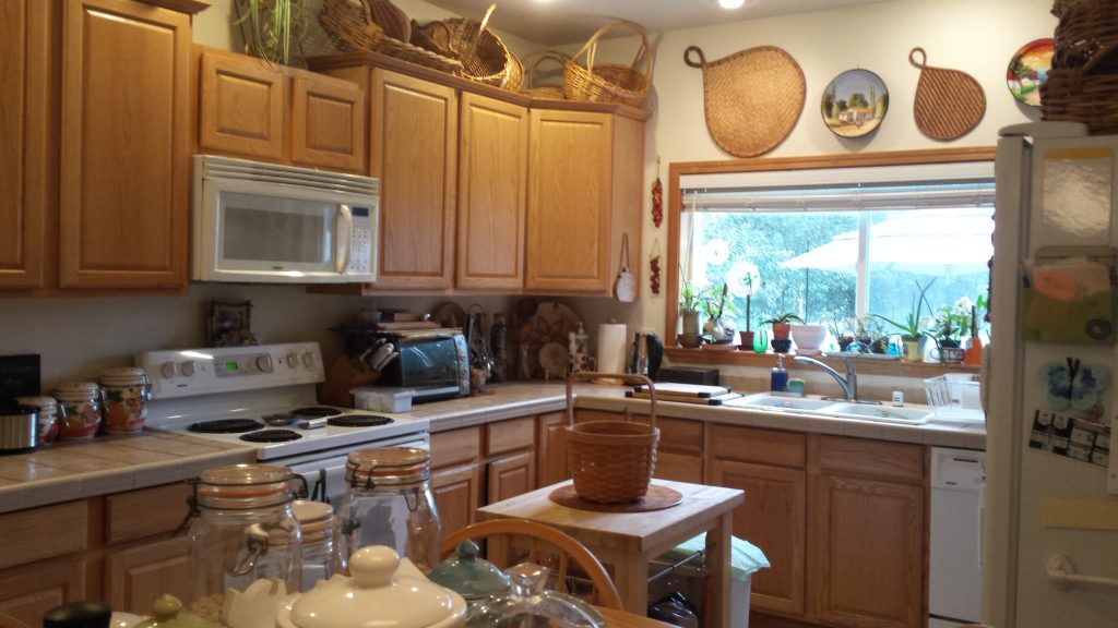 Kitchen before the remodel, with oak cabinets and tile counters