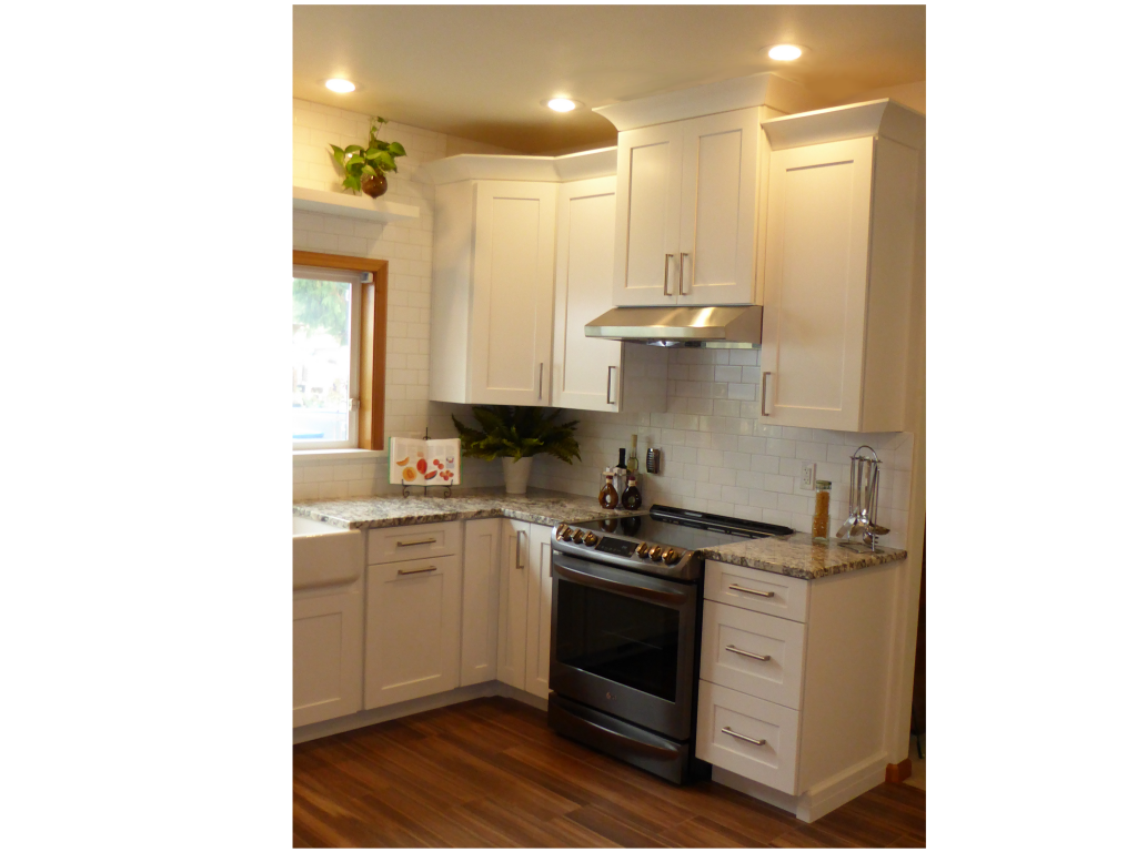 Remodeled kitchen with white shaker cabinets, granite counters, and a new range